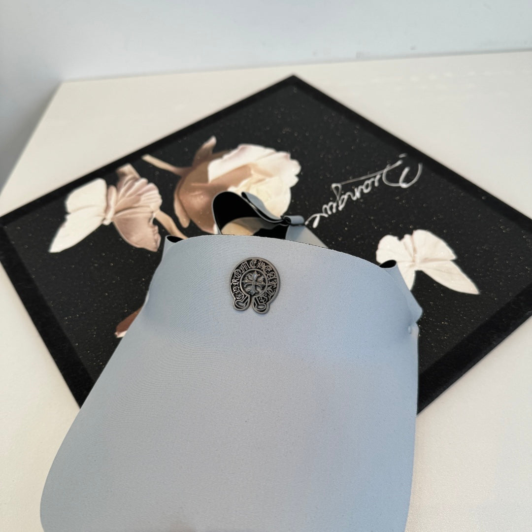 A Chrome Hearts open-top sun visor.