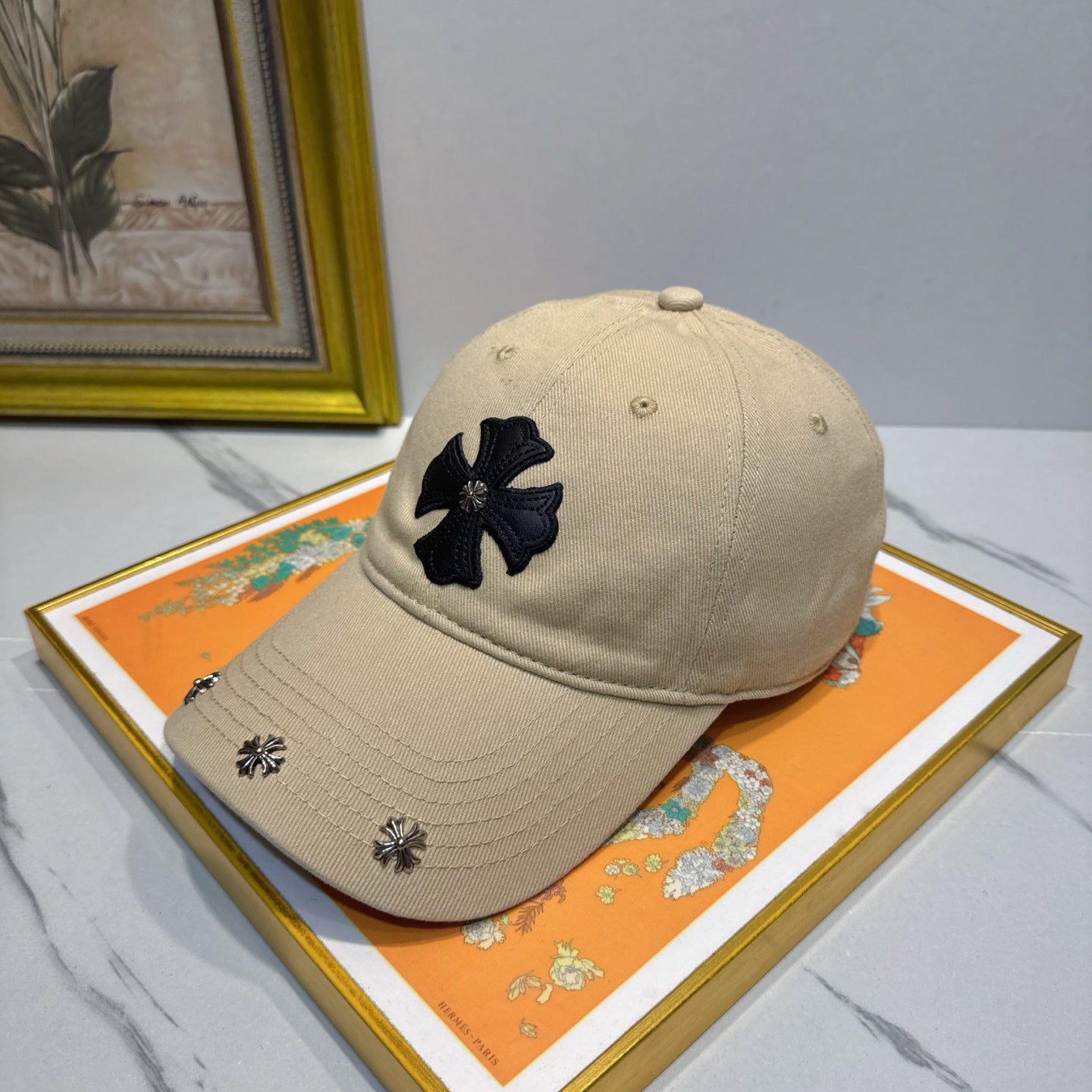 A cream-colored baseball cap by Chrome Hearts.
