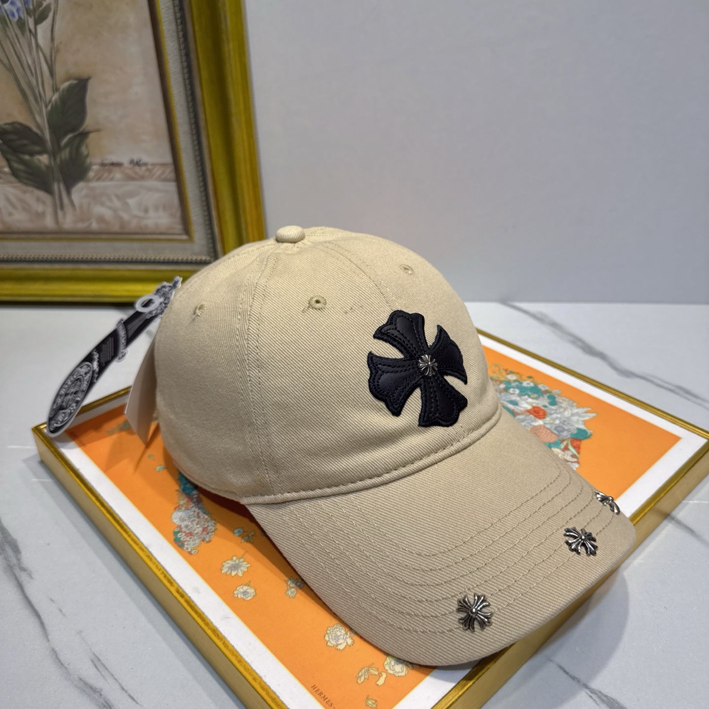 A cream-colored baseball cap by Chrome Hearts.