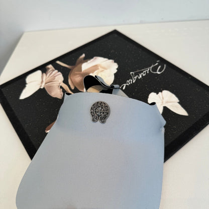 A Chrome Hearts open-top sun visor.