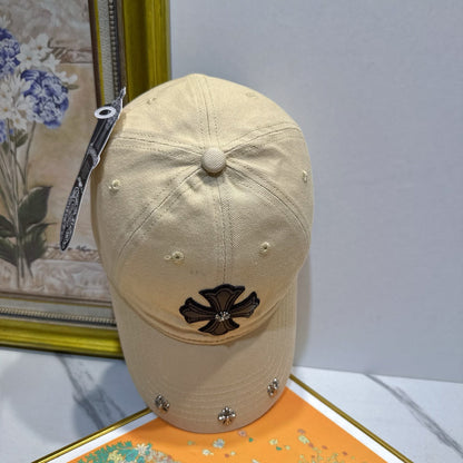 A cream-colored baseball cap by Chrome Hearts.