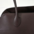 The Row Margaux 15 Smooth Calfskin Handbag | Large Leather Tote with Side Buckles | Black / Dark Chocolate