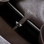 The Row Margaux 15 Smooth Calfskin Handbag | Large Leather Tote with Side Buckles | Black / Dark Chocolate